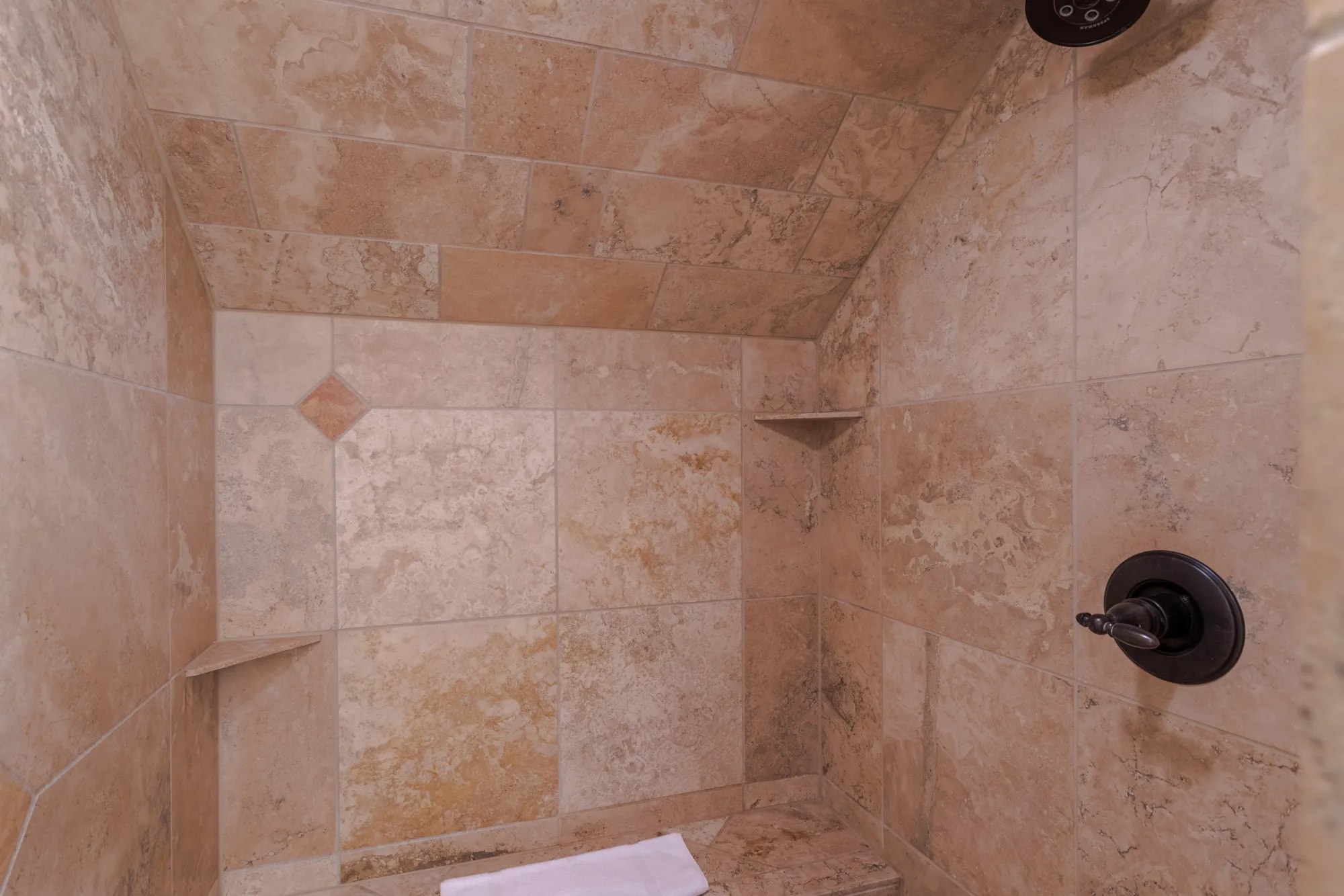 Walk-in travertine shower