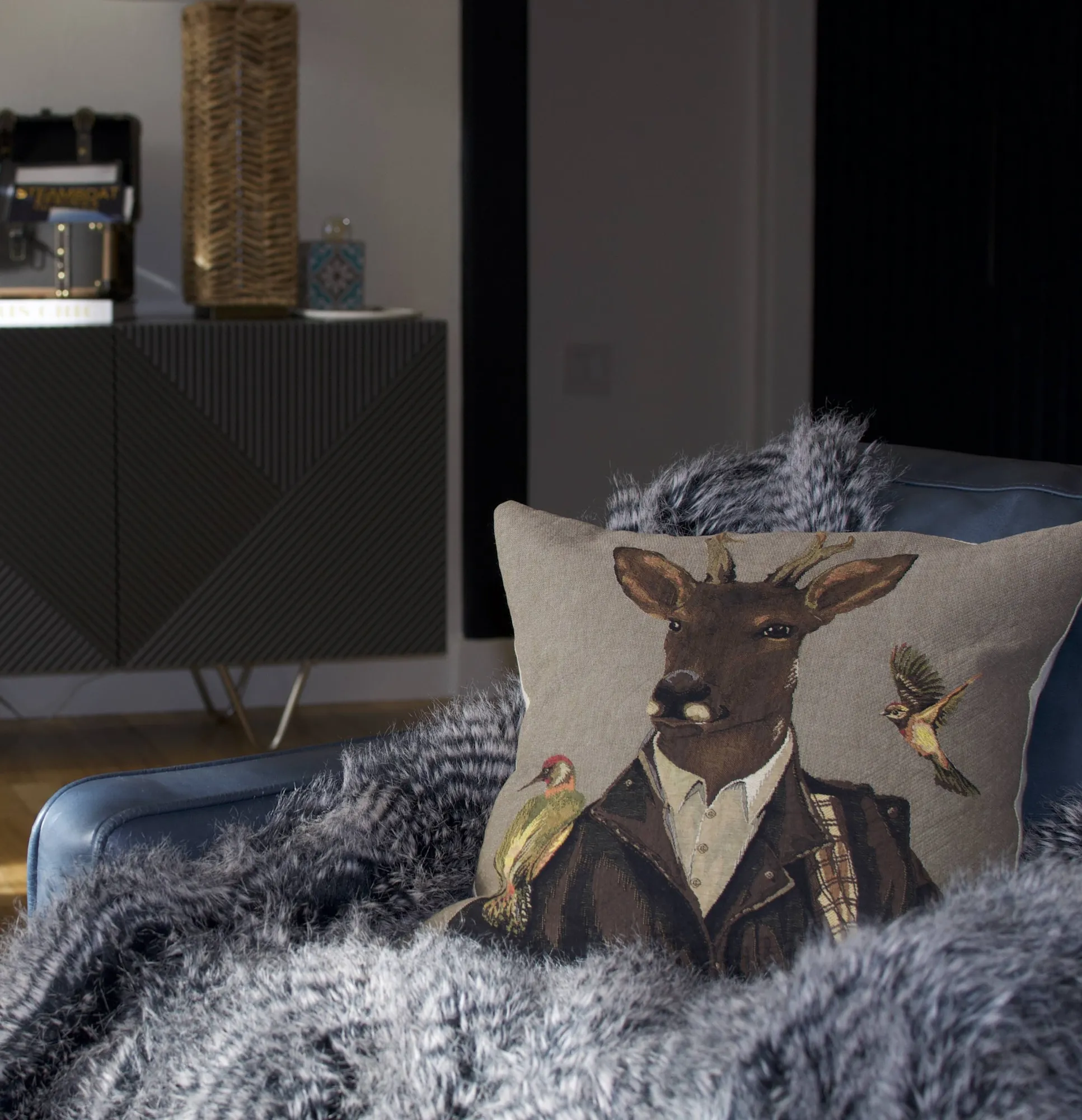 Deer pillow on the blue chair